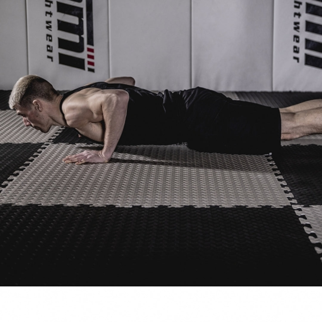 man exercising on foam mat