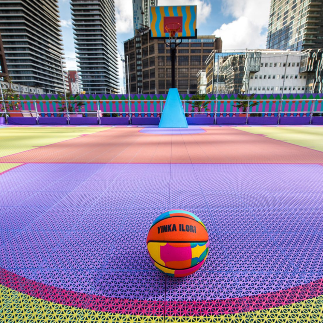 Bright coloured modular basketball tiles in an outdoor basketball court