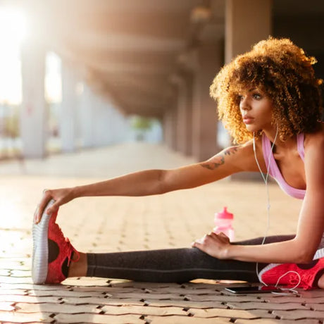 attractive young female stetching on the ground after a run