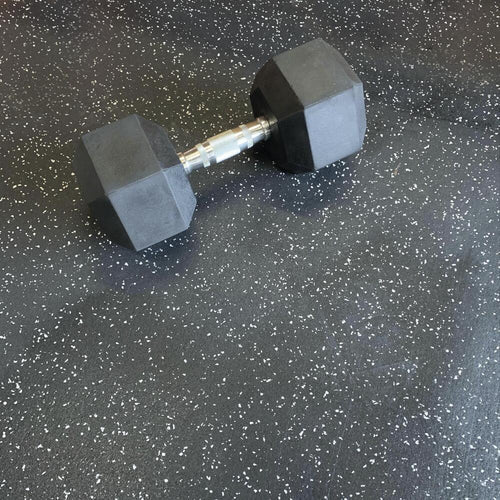 Dumbbell sitting on rubber flooring 