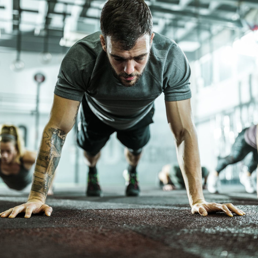 Man doing floor exercise on rubber floor tiles