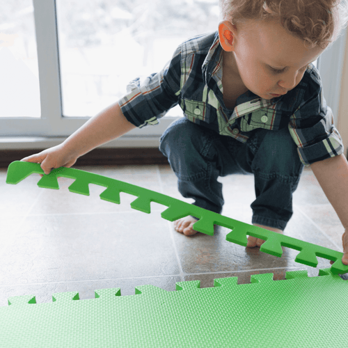 Young child with a foam play mat