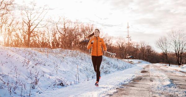 woman jogging in snowy winter weather